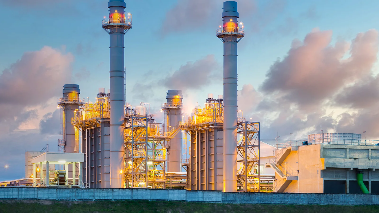 Large industrial power plant boiler and steam generation facility at dusk